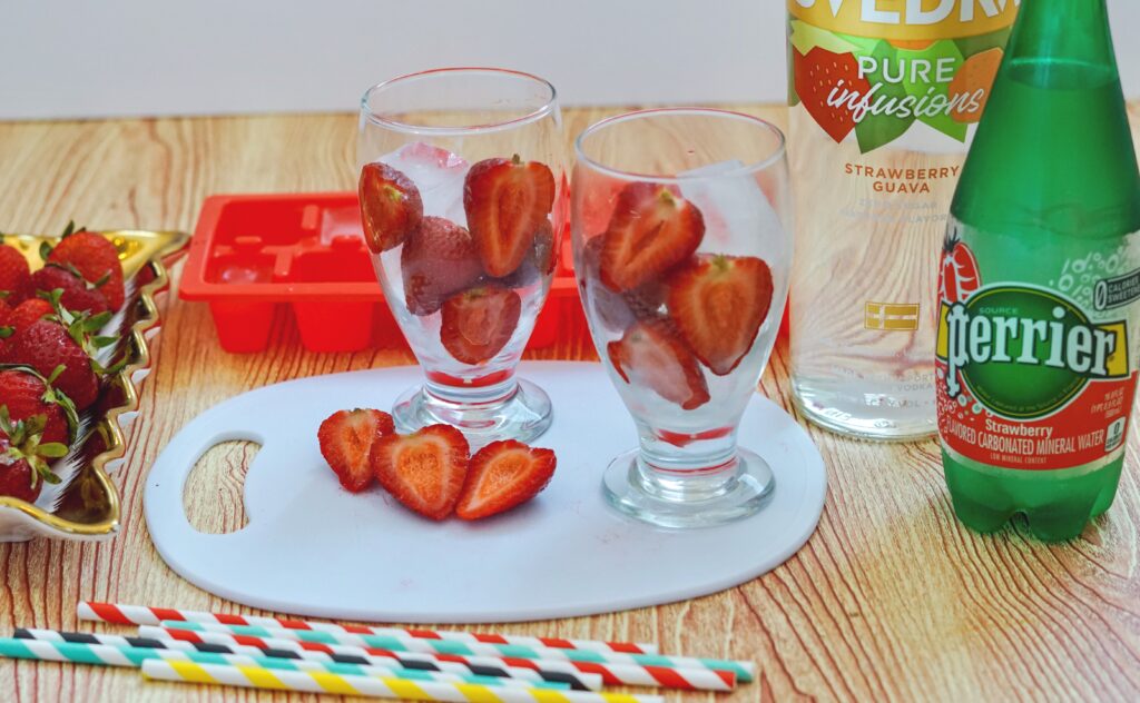 cut up strawberries in glass for guava cocktail