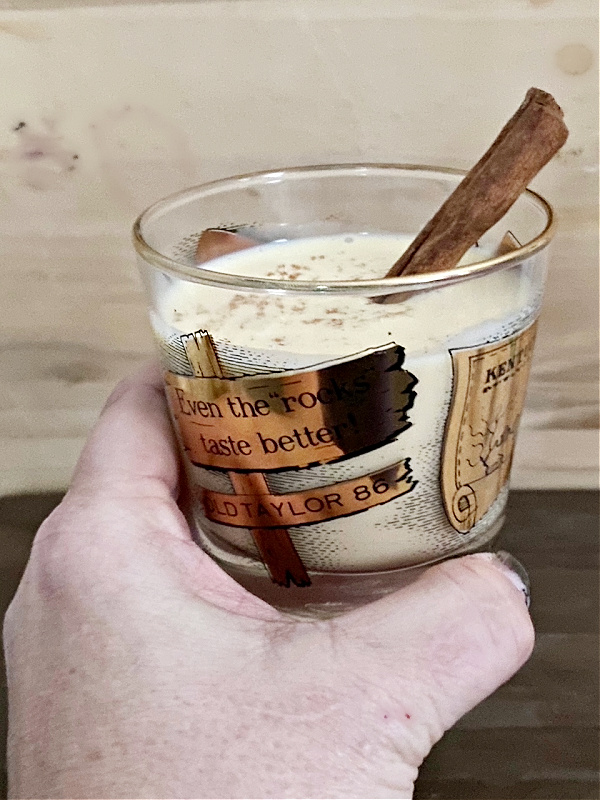 spiked eggnog with cinnamon stick