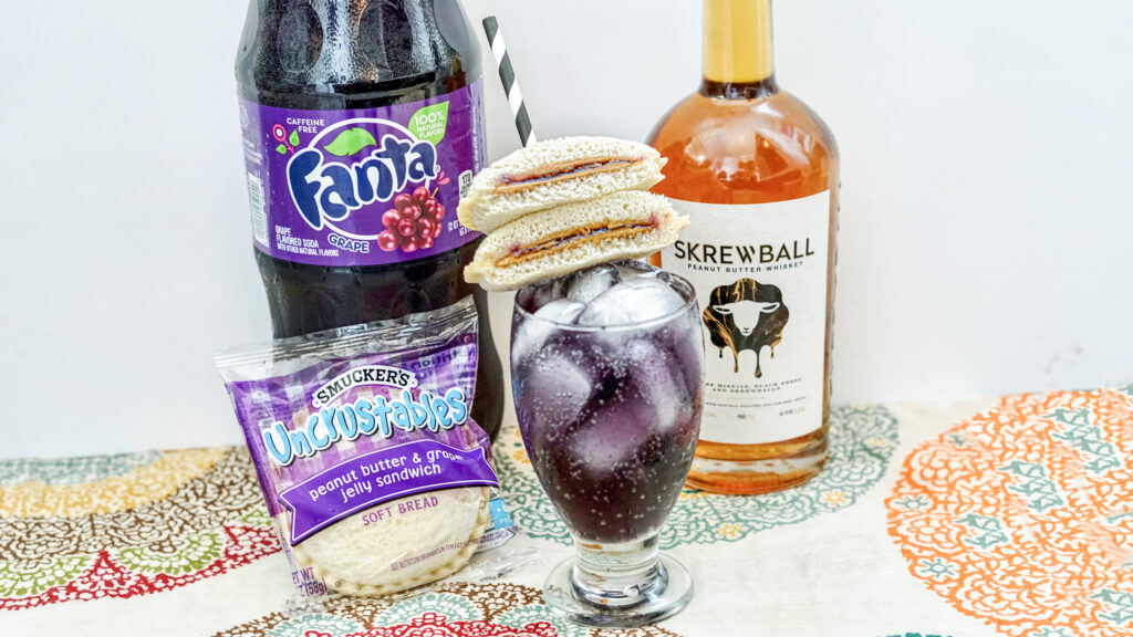 Peanut Butter & Jelly Whiskey Cocktail on counter with grape soda