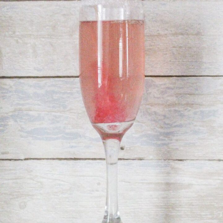 single champagne glass with pink champagne margarita