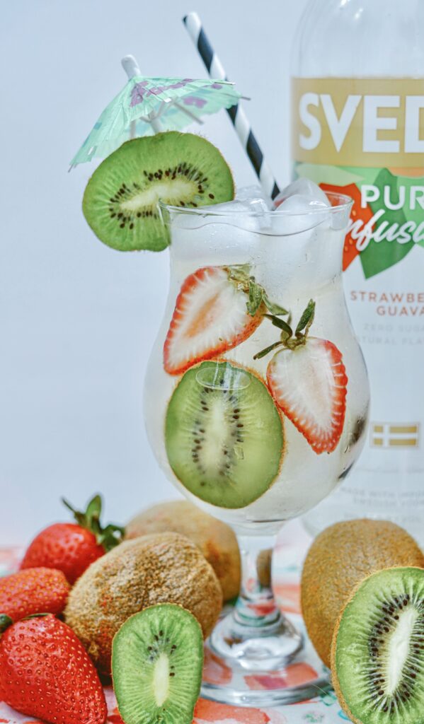  glass with ice cubes, kiwi slices & strawberries.