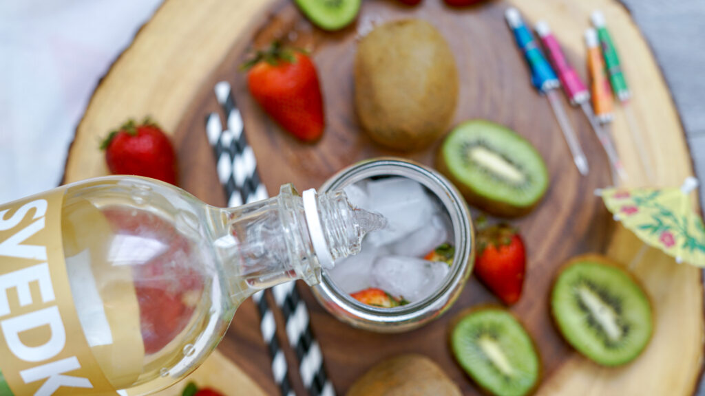 pouring strawberry vodka in glass